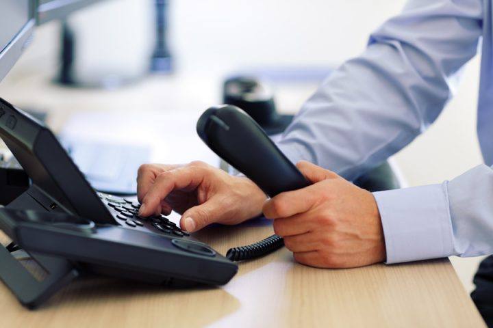 Man on the phone that is a hosted VOIP West Palm Beach